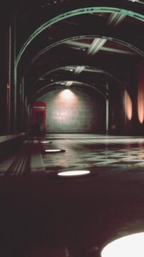 A red telephone box stands alone in an underground station. The area is dimly lit, with shadows on the walls. The floor has lights near the edges. No people are present.