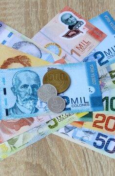 Costa Rican colon money bills and coins on table. Costa Rica cash of CRC currency close up