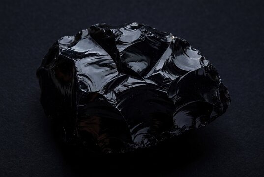 Volcanic obsidian glass sharp fractures abstract black