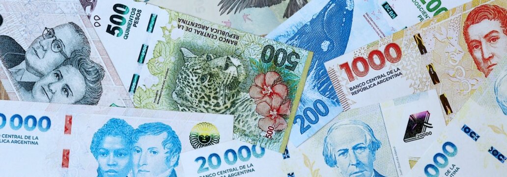 Argentine peso money banknotes bunch on table. Argentina bills of ARS currency close up