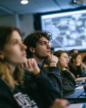 A university classroom of young adults exchange doubtful looks while AI diagrams glow on a projector screen, thoughtful mood, cool overhead lighting, diagonal composition.