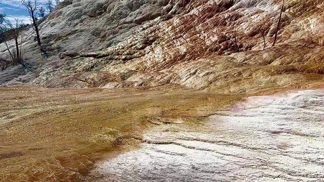 Hot water running down rock and mineral formations at  colorful hot springs