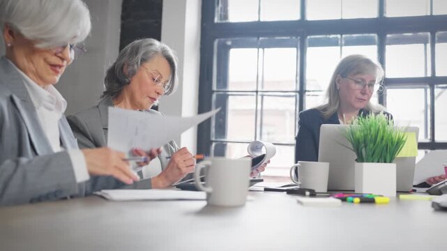 Group of confident women in office, strategic thinking and decision making. Senior professional ladies discussing management and finance, empowered women, emancipation and confidence, female power
