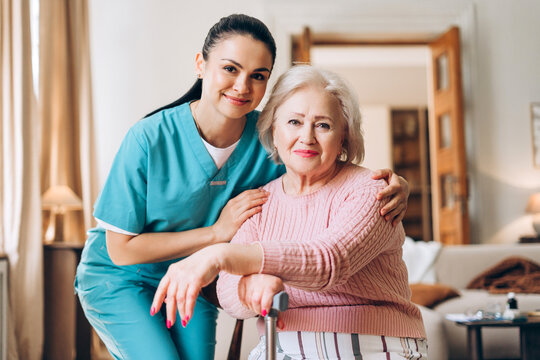 Caregiver supporting senior woman with home healthcare