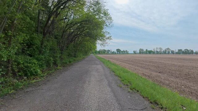 Immersive POV from a bike ride on KATY trail near Hermann, Missouri - springtime morning after heavy storm