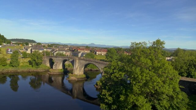 Aerial rising shot revealing the historic medieval Stirling Old Bridge over the River Forth in Scotland