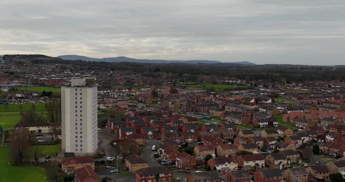 Aerial view of residential housing estate with prominent tower block and surrounding neighbourhood in Redcar North Yorkshire showing suburban streets family homes green spaces and distant hills