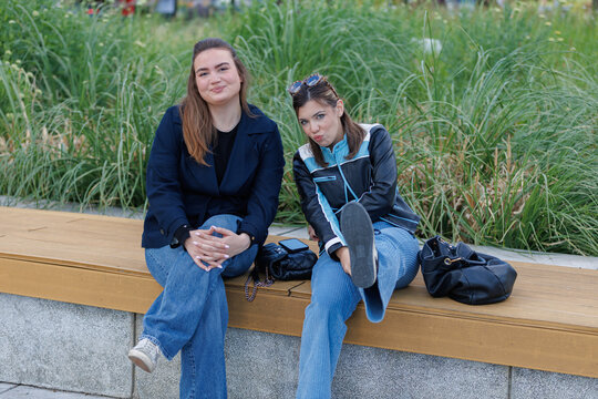 two Gen Z girls sitting on the bench