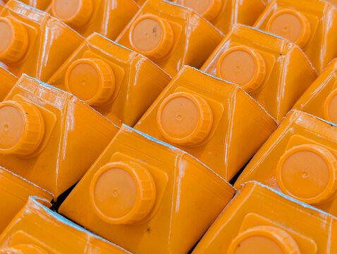 bright orange beverage carton with matching screw cap,