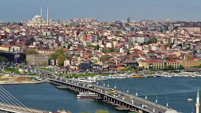 panoramic view of the historic city of istanbul with the golden horn perspective, a bridge with vehicles, mosque and urban area.