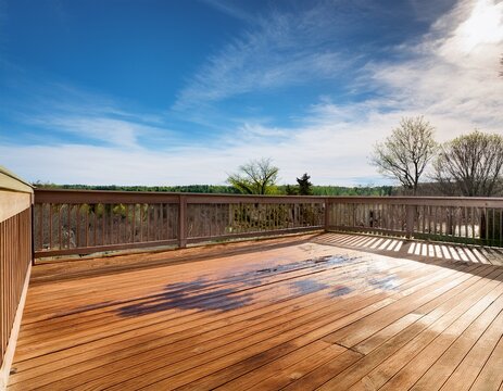 freshly stain large home walk out cedar wood deck patio during early spring