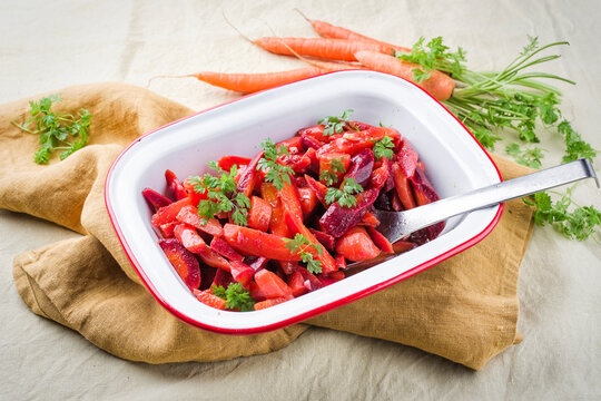 Easy homemade carrot salad with marinated carrots and beets served as close-up in a design bowl