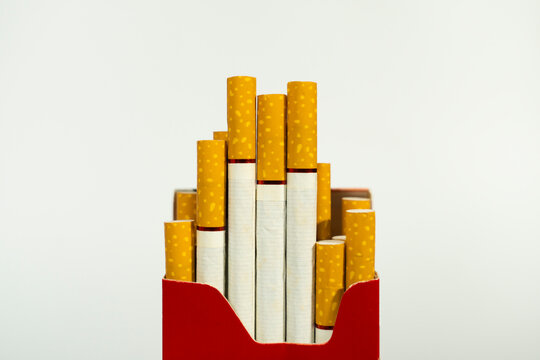 Studio shot of partially full red pack of cigarettes with cigarette addiction nicotine unhealthy abstinence lifestyle