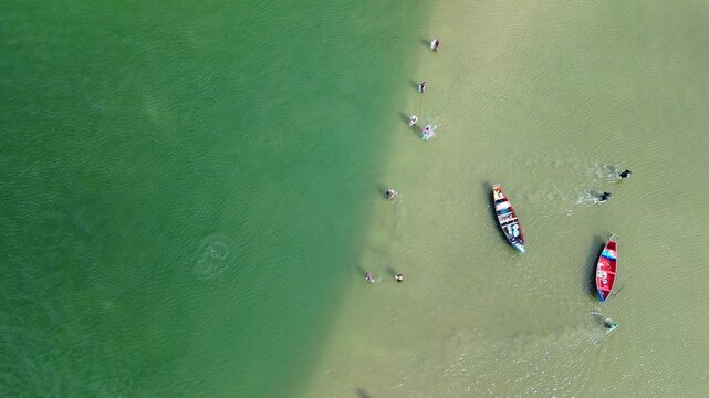Fishing with dolphins, authentic fishing tradition in Brazil. Aerial view of the group of fishermen collaborating and fishing together with dolphins