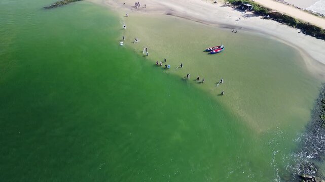 Fishing with dolphins, authentic fishing tradition in Brazil. Aerial view of the group of fishermen collaborating and fishing together with dolphins