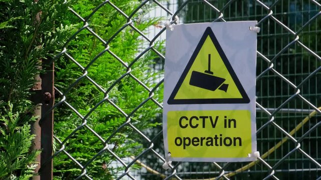 CCTV in Operation Warning Sign Mounted on Chain Link Security Fence