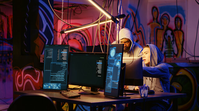 Hackers in dark room discussing ways to breach defenses and exploit weaknesses in PC systems, evil computer scientists in hidden base getting past companies security networks.
