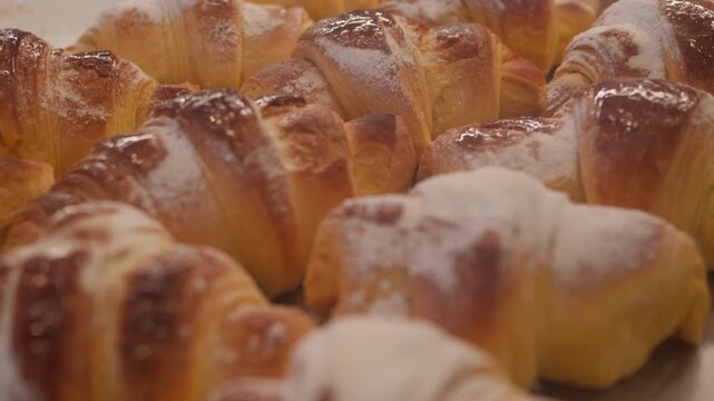 Freshly baked, golden croissants lined up for customers in a warm Parisian bakery. The sweet aroma fills the air, inviting all to enjoy a delightful treat.