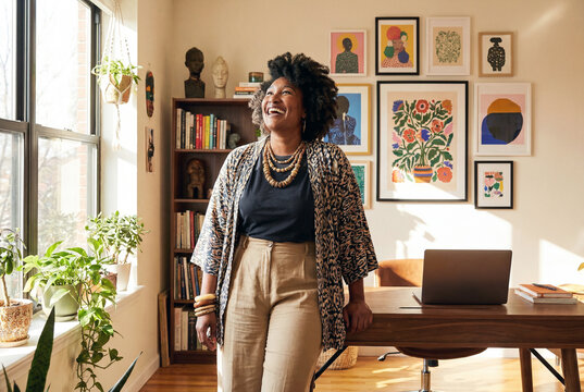 Portrait of happy confident black woman in her home office space