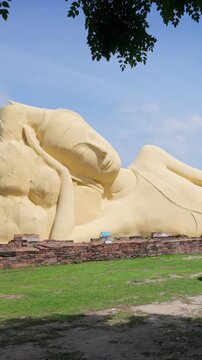 The Reclining Buddha statue at Ayutthaya, Thailand, is a sacred Buddhist monument. Depicts Buddha in a state of parinirvana, symbolizing his final entry into nirvana.