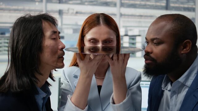 Diverse technicians assessing semiconductor substrate material quality close up in factory office, studying silicon wafer, electronics and diverse coworkers squinting eyes for semiconductor research.