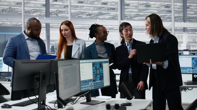 Portrait of smiling diverse engineering team optimizing PCB production in factory office, cheerful colleagues using devices, collaborating to improve microchip processing efficiency.