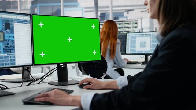 Mockup green screen PC used by woman in microchip factory office to optimize production, worker using chroma key isolated screen computer to improve semiconductor processing efficiency.