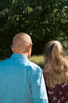 a businessman and female colleague standing together outdoors, concept of looking forward to future corporate goals