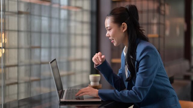 Businesswoman working on laptop in modern office