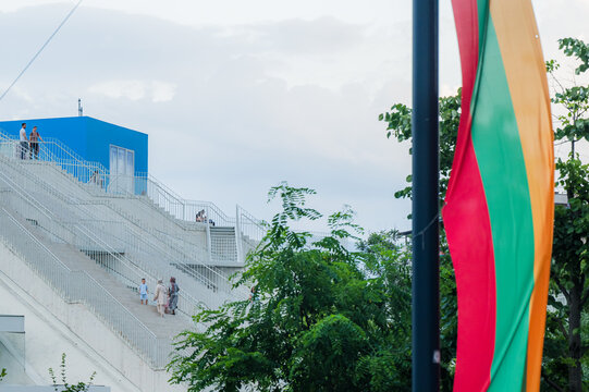 Tirana, Albania - 03 June 2026: View of the Pyramid of Tirana with people walking on the white concrete stairs and a blue cube structure on top.