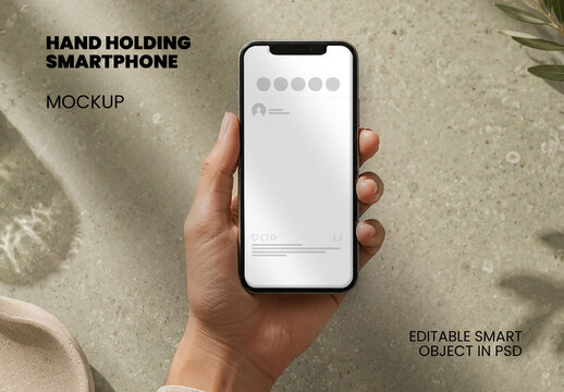 Hand Holding Smartphone On Desk Mockup