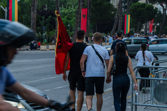 Tirana, Albania - 03 June 2026: View of protesters walking along a city street with an Albanian flag during a public demonstration.