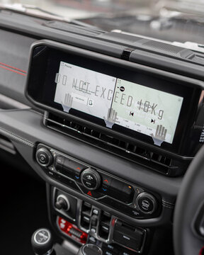 Close up of car stereo head unit on vehicle dashboard.