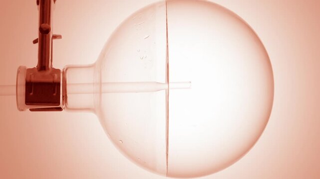 Colorless transparent liquid injected via long dropper into round-bottom flask, making swirls and bubbles on beige dome-like ramp bg | Make-up remover product commercial concept