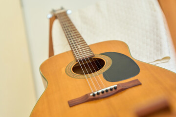 Fototapeta premium Close up of acoustic folk guitar strings and soundhole with wooden body