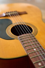 Fototapeta premium Close up of acoustic folk guitar strings and soundhole with wooden body