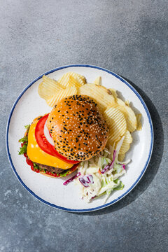 Homemade Cheeseburger with Barbecue Food and Sides