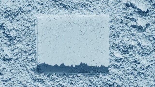 Vertical arc perspective shot of a pale blue natural powder surface showing a distinct rectangular mark orbiting directional light creates flowing, dynamic shadows