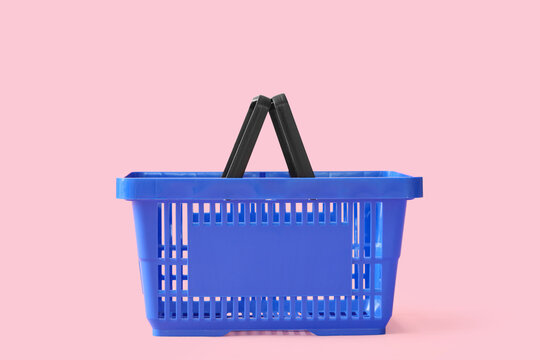 Blue shopping basket on pink background