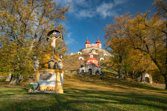 View of the Kalvaria Banska Stiavnica baroque complex with red-roofed chapels on a hill surrounded by autumn trees Banska Stiavnica, Banskobystricky kraj, Slovakia.