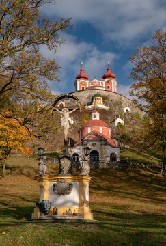View of the Calvary of Banska Stiavnica with the Upper Church and a crucifix statue surrounded by autumn foliage Banska Stiavnica, Banskobystricky kraj, Slovakia.