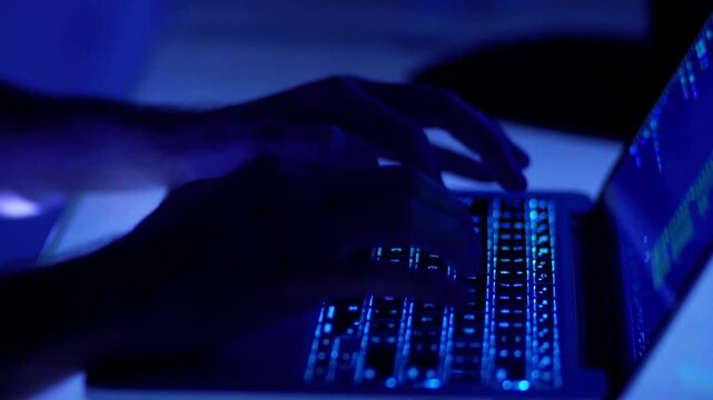 Deep Work Concentration of Man on Laptop Computer Keyboard in Dark Studio Room in 4K Ultra HD footage
