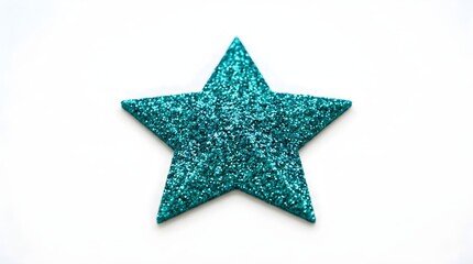 Obraz premium A single decorative teal glitter star shape lies flat against a bright luminous surface catching the light with its shimmering texture and pointing towards the top of the frame symbolizing