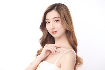 Fototapeta premium A beautiful young Asian woman with clean, fresh skin against a white background. Skincare, facial treatment, cosmetology, beauty, and spa. An elegant portrait of an Asian woman.