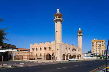 Fototapeta premium King Faisal Mosque with twin minarets and beige stone facade in Taif, Saudi Arabia