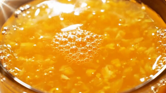 Top down macro view of orange juice with pulp, tiny bubbles forming and shifting across the surface as camera slowly rotates, highlighting fresh citrus texture, natural juice and refreshing beverage