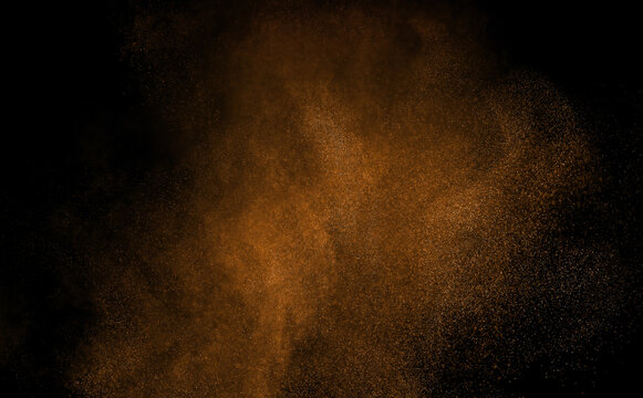 Abstract brown dust particles floating on black background. Realistic powder cloud dispersion with dynamic motion, airborne texture and glowing particle effect for overlays, design and visual effects.