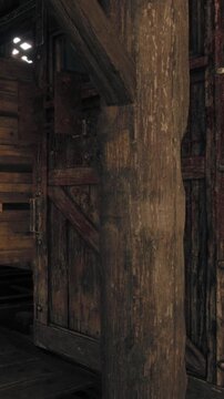 A wooden door is partially visible next to a wooden beam inside a building. The room has a rustic style with old wood materials. The space feels historic and traditional.