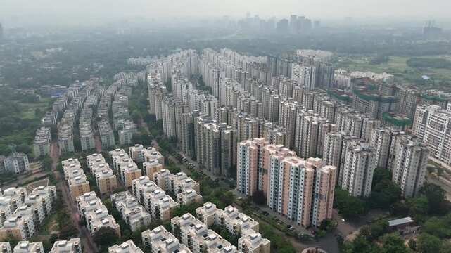 A striking aerial drone perspective of rows of newly constructed high-rise residential towers by the Shapoorji Pallonji Group in Kolkata, West Bengal, India.