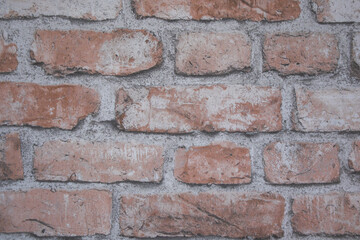 Fototapeta premium Close-up of an aged red brick wall with visible mortar joints and weathered texture. Detailed masonry background suitable for construction